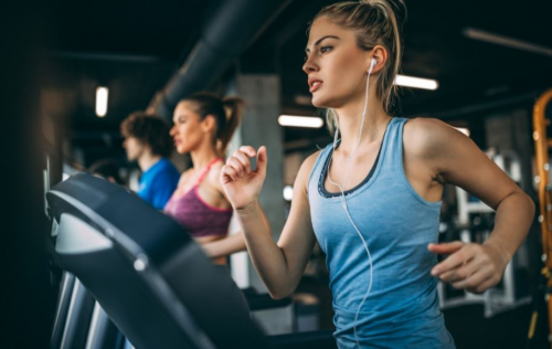 Koşu bandında koşan kadın.